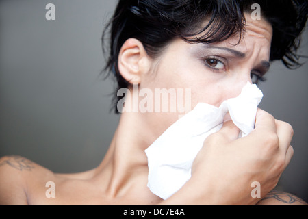 woman blowing her nose. Stock Photo