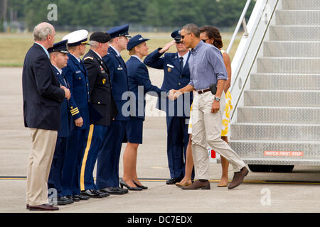 US President Barack Obama greets base commanders after landing aboard Air Force One at Joint Base Cape Cod August 10, 2013 in Buzzards Bay, MA. The Obama's are on their way to Martha's Vineyard for summer vacation. Stock Photo