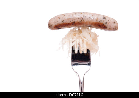 Nuremberger bratwurst with sourcrout on fork white islated Stock Photo