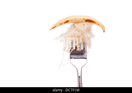 White isolated swabian schupfnudel with sourcrout on a fork Stock Photo