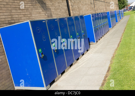 A row of blue BikeAway bicycle lockers on the campus of the University of Bolton near College Way/Derby Street. Stock Photo