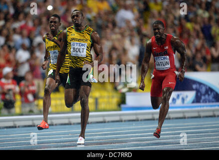 Moscow, Russia. 11th Aug, 2013. Usain Bolt of Jamaica (C) wins the 100m final ahead of Justin Gatlin (R) of the US at the 14th IAAF World Championships in Athletics at Luzhniki Stadium in Moscow, Russia, 11 August 2013. At Left Jamaica's Kemar Bailey-Cole. Photo: Bernd Thissen/dpa/Alamy Live News Stock Photo