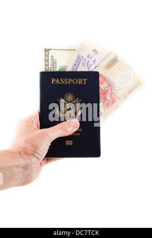 American passport with different currencies inside of it isolated on a white background Stock Photo