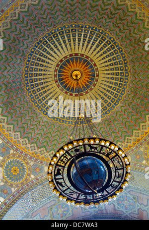 Under a painted sunburst, the 1927 Globe Chandelier hangs from the ceiling of the downtown Los Angeles Public (Central) Library in California, USA. Stock Photo