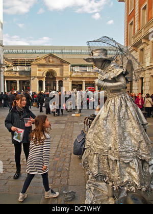 Children Looking at Human Statue in Covent Garden Westminster London United Kingdom England Stock Photo
