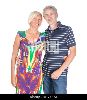 Smiling attractive middle-aged couple standing close together looking at the camera isolated on white Stock Photo