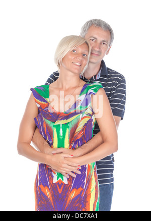 Affectionate middle-aged couple standing in a close embrace, on white Stock Photo