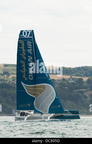 Isle of Wight, UK. 11th Aug, 2013. Oman Air - Musandam, a MOD 70 trimaran (OMA07 sail number) in the MOCRA multihull class second in the field at the start of the Fastnet 2013 race shortly after departing from Cowes on the 11th August 2013 Credit:  MeonStock/Alamy Live News Stock Photo