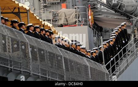Crew members stand on deck of the Japanese school ship 'Kashima' at the port of Kiel, Germany, 12 August 2013. For the first time in 22 years, the Japanese naval force visited Kiel. The training ship and two destroyers will stay in Kiel for three days. Photo: CARSTEN REHDER Stock Photo