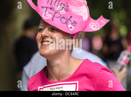 Woman in a silly hat on a race for live event UK Stock Photo