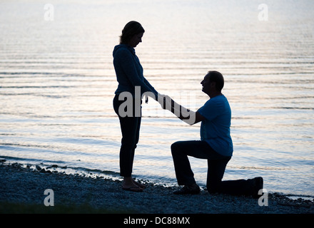 A man is doing a marriage proposal to his girlfriend Stock Photo