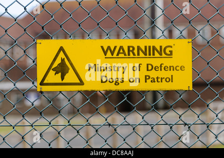 Sign at a military site warning that dogs are on patrol