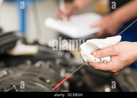 Closeup of the hand of car mechanic checking oil Stock Photo