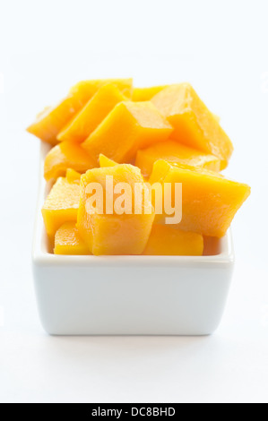 Mango Cubes on a white dish Stock Photo