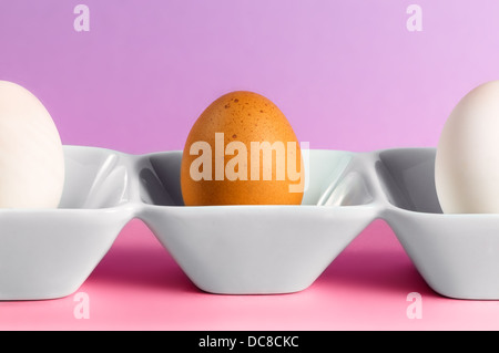 An egg and two halves standing on a dish Stock Photo