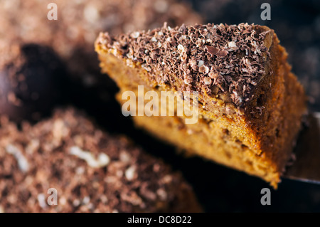 Slice of a chocolate cake raised up. Close up shot Stock Photo