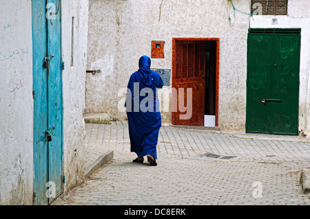 Woman walking by the streets of Moulay Idriss. Morocco Stock Photo