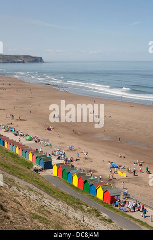 Whitby bay's brightly coloured beach huts and sandy bay/beach. Stock Photo