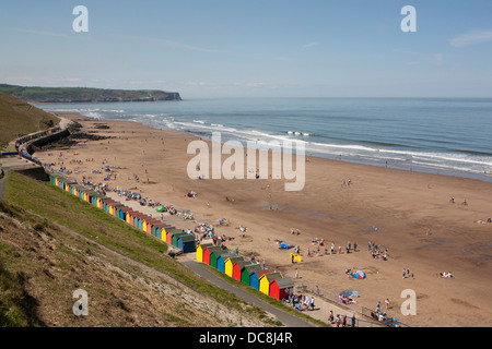 Whitby bay's brightly coloured beach huts and sandy bay/beach. Stock Photo