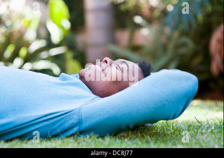 Young man lying on the grass Stock Photo