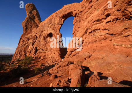 Hiker Exploring the Turret Arch in Arches National Park, Utah, USA at Sunrise Stock Photo