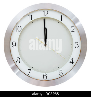 one minute to twelve o clock on the dial round wall clock Stock Photo