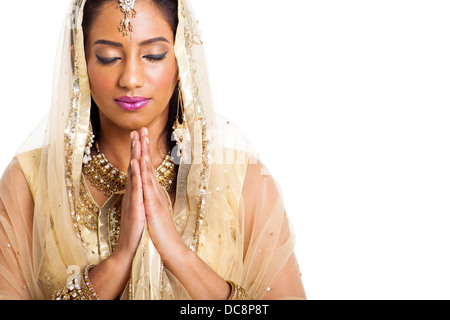 beautiful Indian woman praying with eyes closed on white background Stock Photo