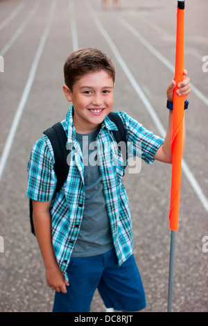 a boy stands and holds a school crossing guard flag Stock Photo