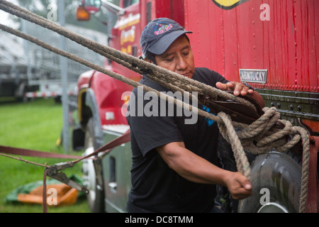 Workers set up a tent in the rain for a performance of the Kelly Miller Circus. Stock Photo