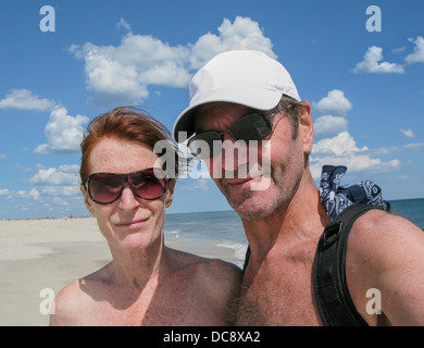 senior couple on shoreline at beach Stock Photo