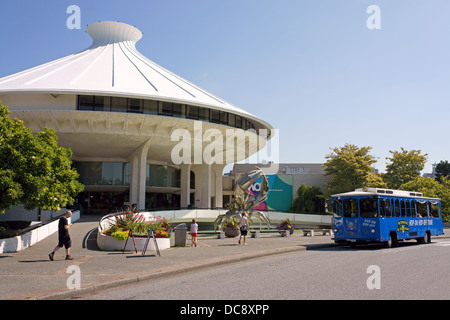 Hop on hop off tour bus and family in front of the H.R. Macmillan Space Centre  and Vancouver Museum, Vancouver, BC, Canada Stock Photo