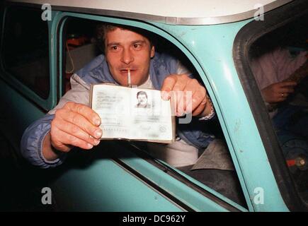 A GDR Citizen shows his ID at border crossing Helmstedt, Germany, 10 November 1989. Millions of GDR citizens travelled from East to West one day after the opening of the German-German border in the night of 09 to 10 November. Stock Photo