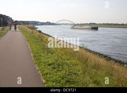 Path along raised flood defence dyke alongside River Nieuwe Maas Alblasserdam Netherlands Stock Photo