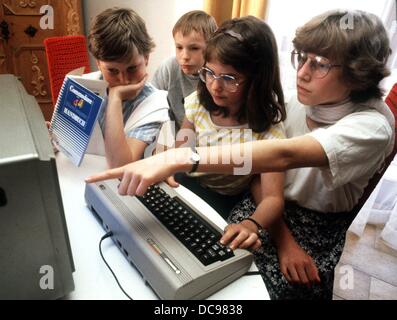 Adolescents try out a Commodore 64 in Nuremberg in May 1985. Stock Photo
