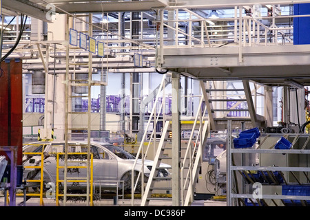cars in a row on conveyor at car plant Stock Photo