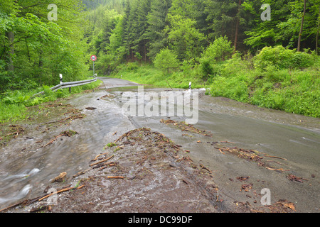 Road in the Harz region covered in water and debris after heavy rainfalls Stock Photo