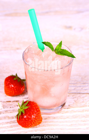 Strawberry slush in glass with straw and berries, close up Stock Photo