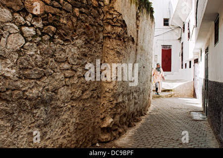 Woman walking on the streets of Moulay Idriss medina. Morocco Stock Photo