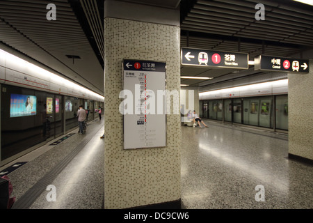 Waiting for a train at Kowloon MTR platform Stock Photo