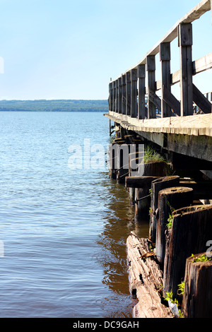 an old wooden pier juts out into the beautiful sparkling waters of Lake Superior Stock Photo
