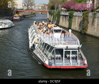 Bateaux-Mouches' on Seine River in Paris, near Notre-Dame. Stock Photo