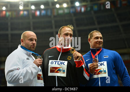 Moscow, Russia. 13th Aug, 2013. Silver medalist Piotr Malachowski (L) of Poland, gold medalist Robert Harting (C) of Germany and bronze medalist Gerd Kanter (R) of Estonia stand on the podium during the medal ceremony of the Men's Discus Throw Event at the 14th IAAF World Championships in Athletics at Luzhniki Stadium in Moscow, Russia, 13 August 2013. Photo: Bernd Thissen/dpa/Alamy Live News Stock Photo