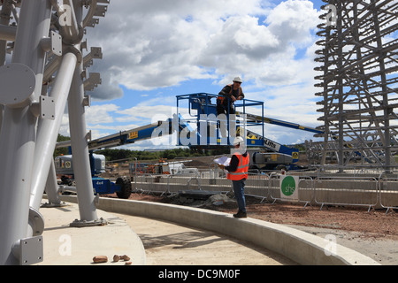 Two construction workers discussing a job looking at drawings Stock Photo