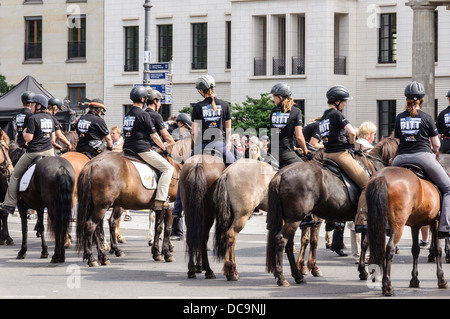 Riders wearing safety helmets, riding Icelandic horses - 17th of June Street Square Berlin Germany Stock Photo