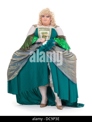 Overweight drag queen in vintage dress and pretty curly blond wig accentuating his weight with Victorian bustles Stock Photo