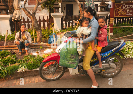 Elk209-1162 Laos, Luang Prabang, produce market, woman and children on motorbike Stock Photo