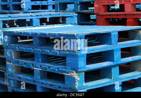 Stacks of pallet crates in red and blue. Stock Photo
