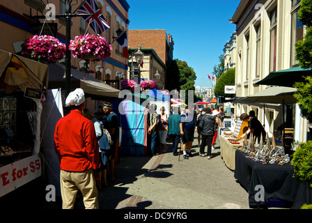 Vendors opening stalls Sunday morning Farmer's Market Bastion Square Victoria BC Canada Stock Photo