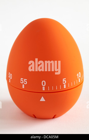egg shaped orange coloured timer egg timer showing time up isolated on white background - 60 minute timer on white Stock Photo