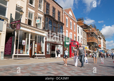 Family walking along Darlington High Row (High street) or town centre, Co. Durham, England Stock Photo